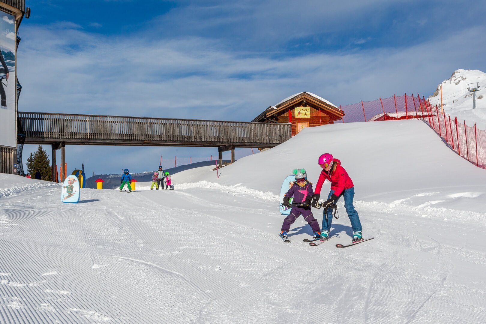 woman teaching a child in ski school Klosters