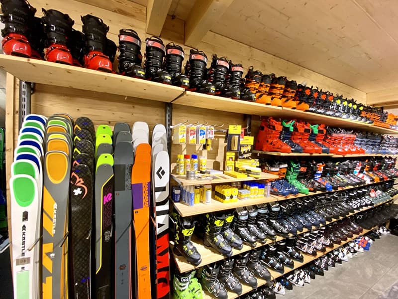 store shelves with ski boots and skis.